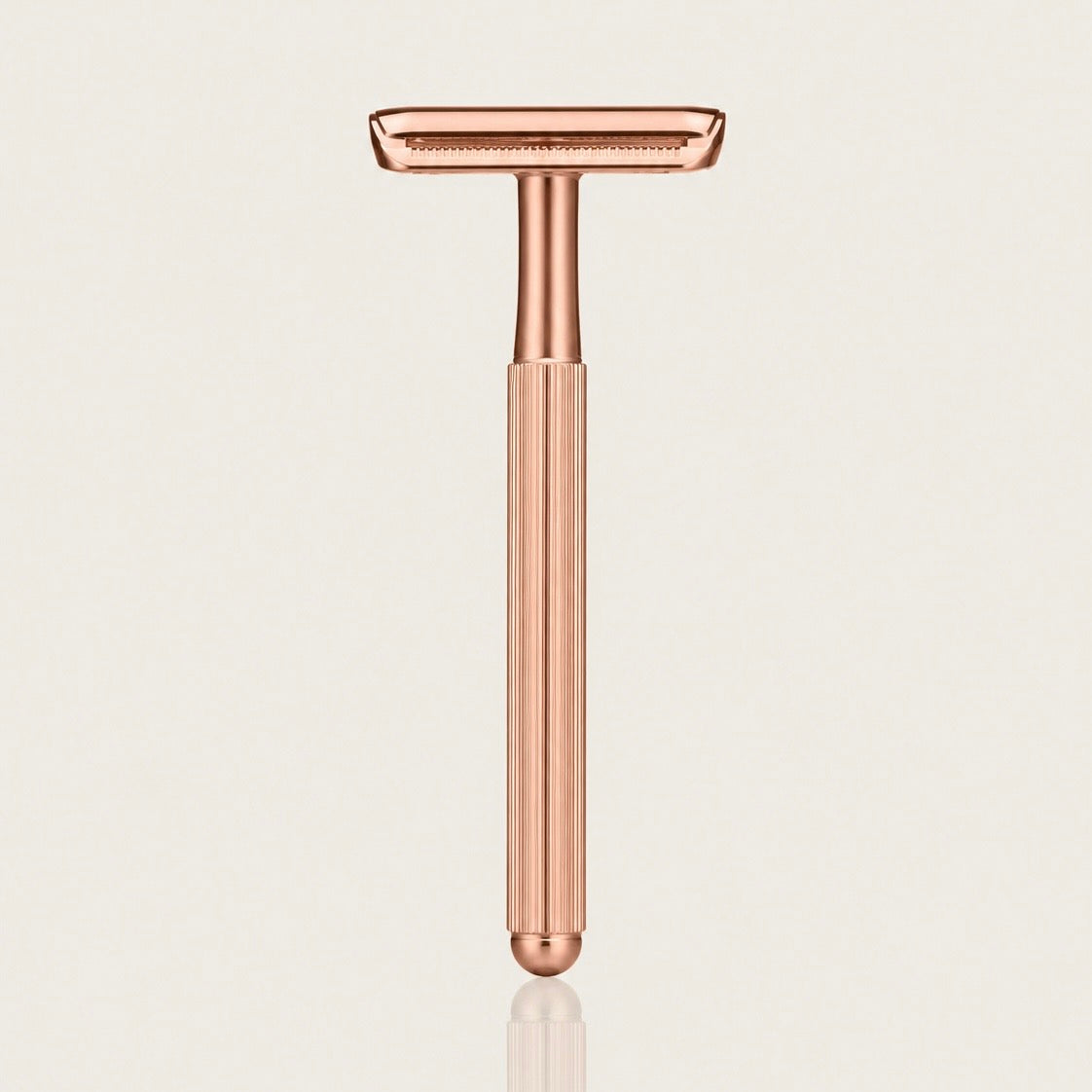 Swanne Razor V2 rose gold safety razor standing upright on a cream background