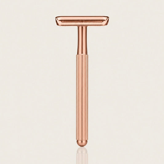 Swanne Razor V2 rose gold safety razor standing upright on a cream background