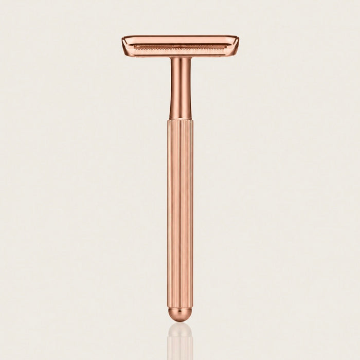 Swanne Razor V2 rose gold safety razor standing upright on a cream background